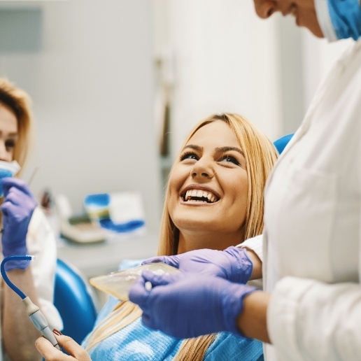 Woman in dental chair smiling at her Chicago dentist