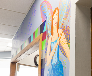 Mural of tooth fairy on wall of Chicago dental office waiting room