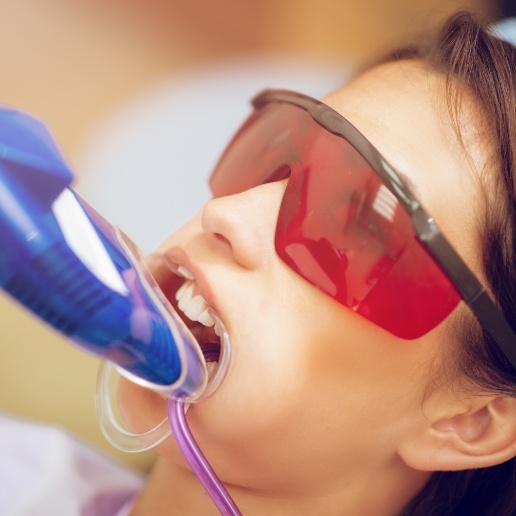 Young girl receiving fluoride treatment at dental office