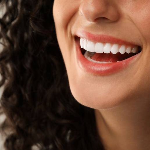 Close-up of woman’s beautiful smile after teeth whitening treatment