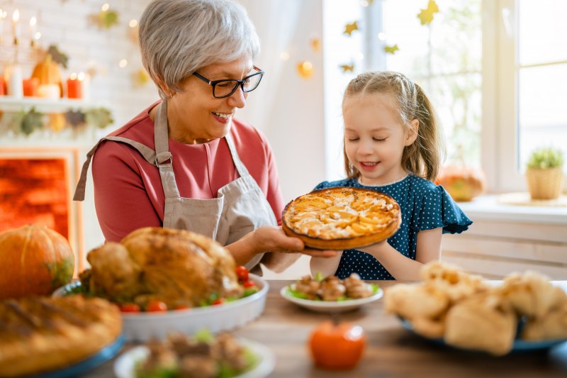 grandmother and granddaughter baking a pie